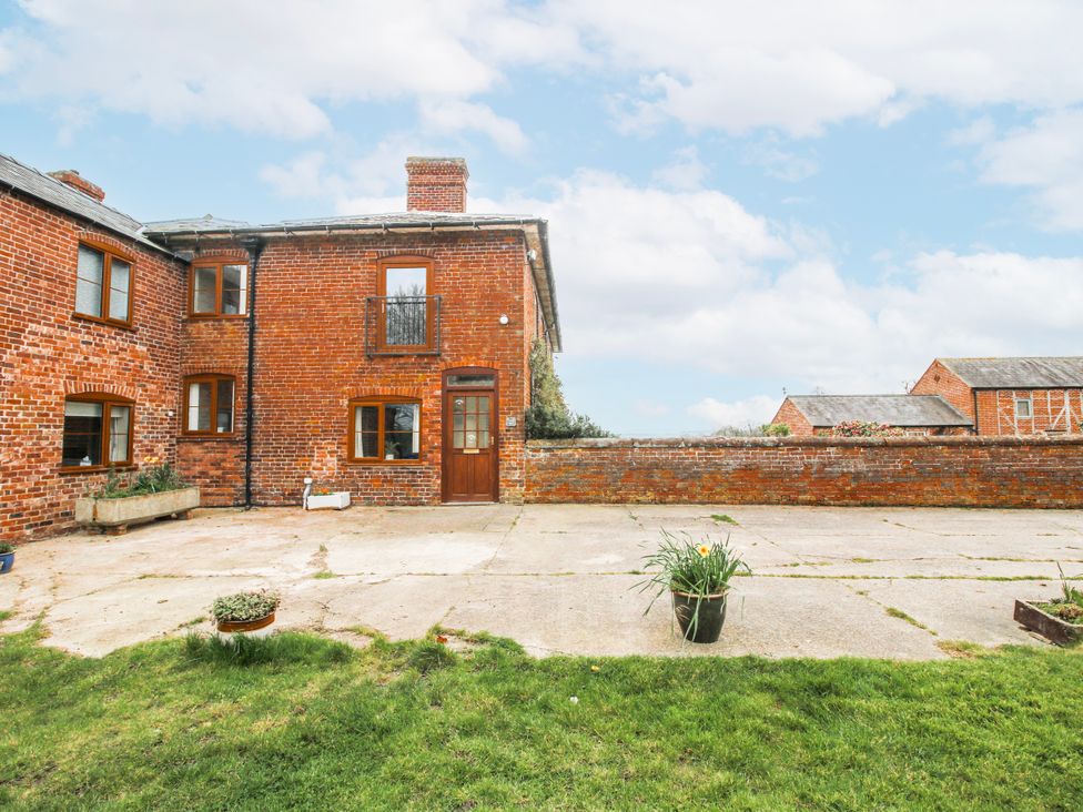 An outdoor area with a brick wall and driveway at The Manor House at Kenwick Lodge Cockshutt near Ellesmere