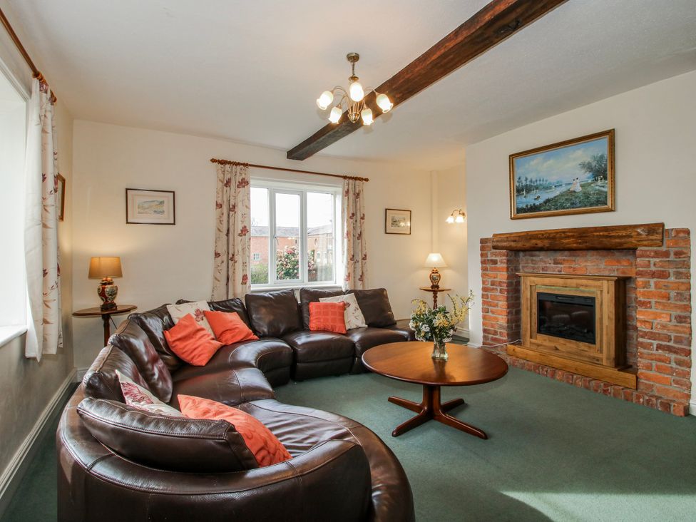 A living room with a sofa and coffee table at The Manor House at Kenwick Lodge Cockshutt near Ellesmere