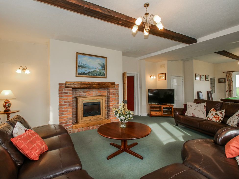 A living room with a sofa and coffee table at The Manor House at Kenwick Lodge Cockshutt near Ellesmere