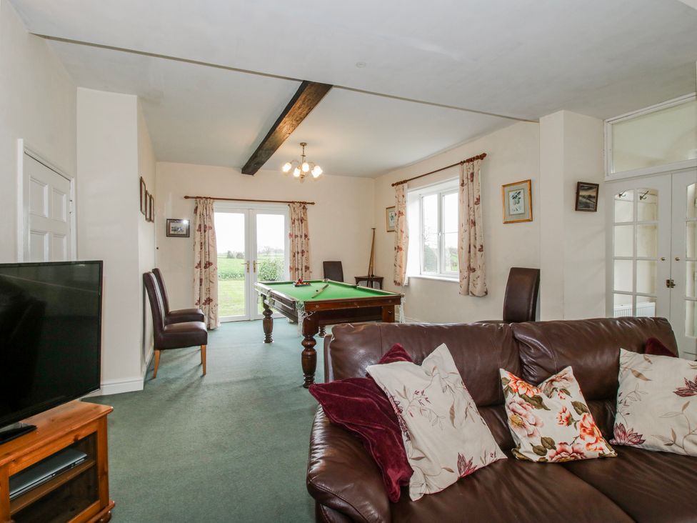 A living room with a sofa, television, pool table at The Manor House at Kenwick Lodge Cockshutt near Ellesmere