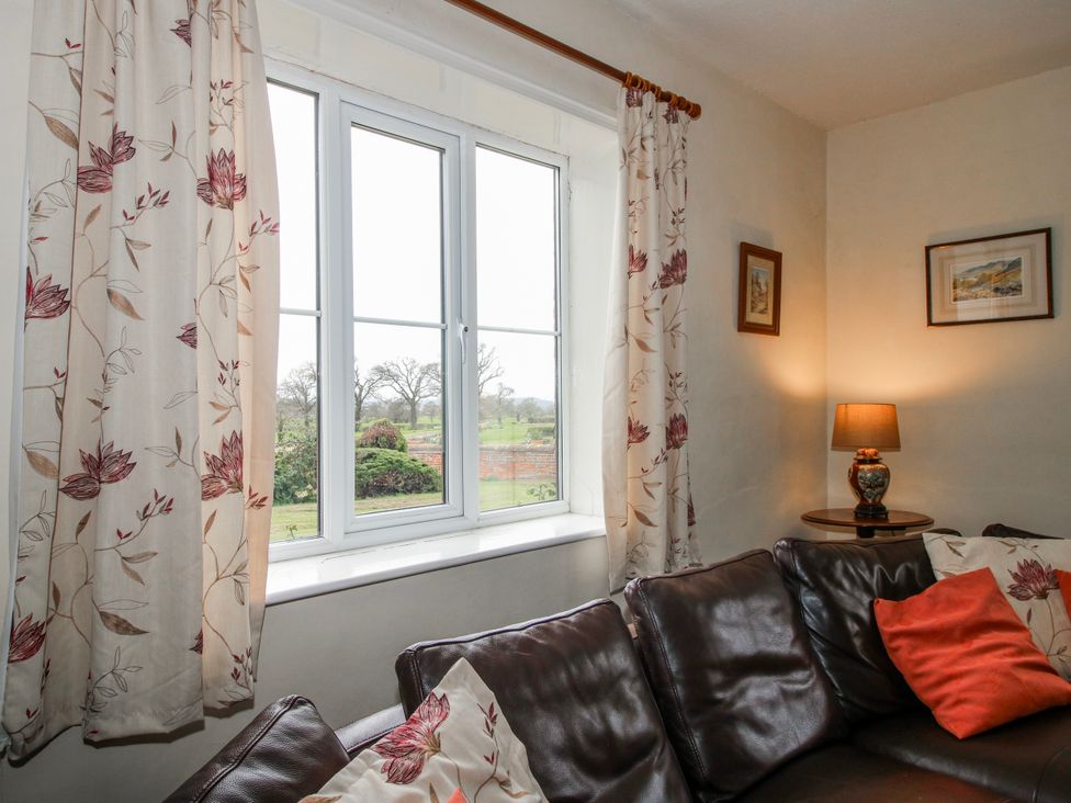 A living room with a window and a sofa at The Manor House at Kenwick Lodge Cockshutt near Ellesmere