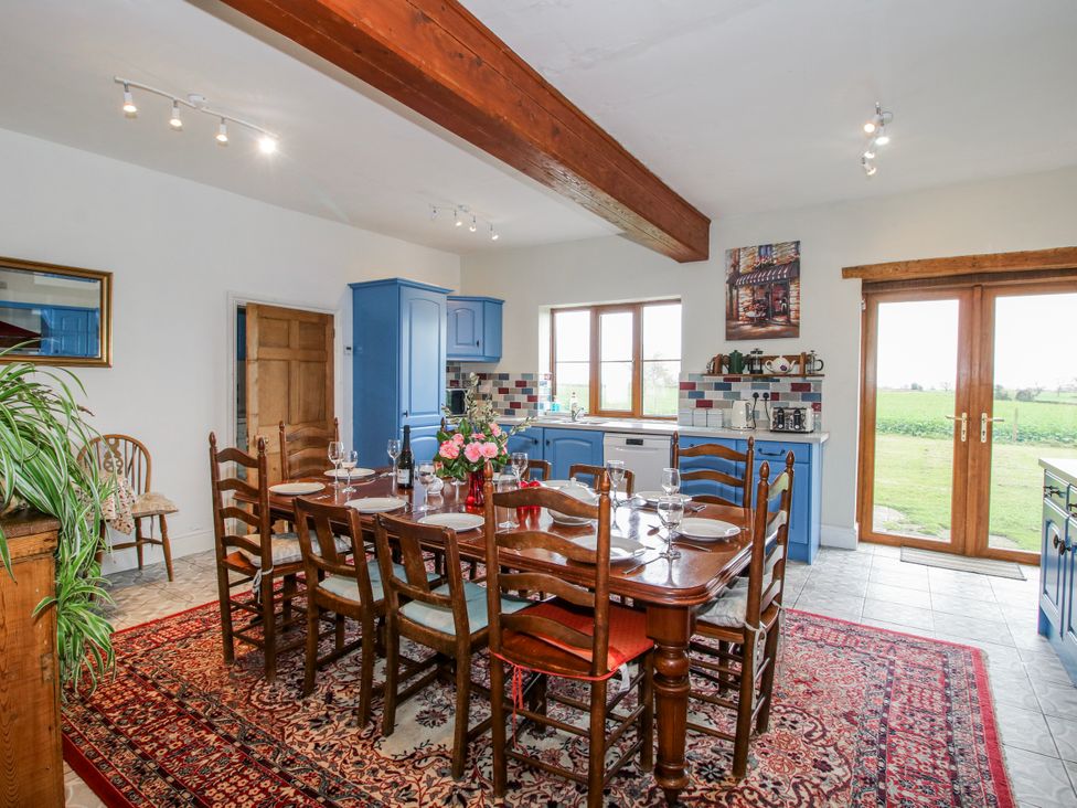 A kitchen with dining table and chairs at The Manor House at Kenwick Lodge Cockshutt near Ellesmere
