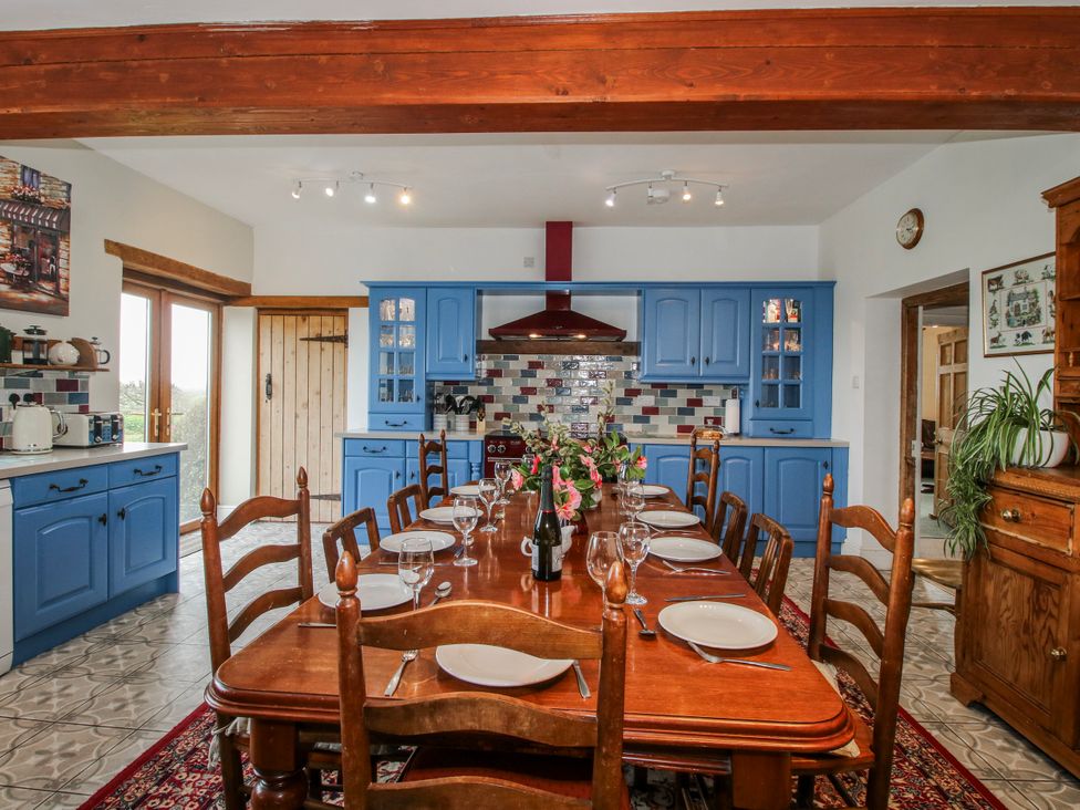 A kitchen with a dining table and chairs at The Manor House at Kenwick Lodge Cockshutt near Ellesmere