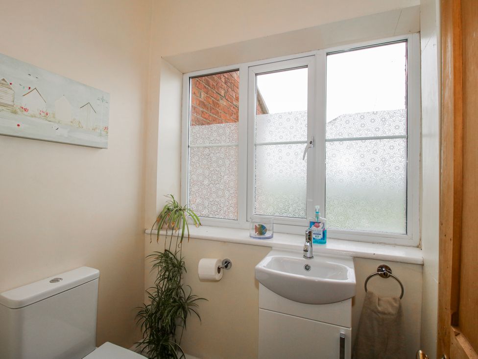 A bathroom with a toilet and sink at The Manor House at Kenwick Lodge Cockshutt near Ellesmere