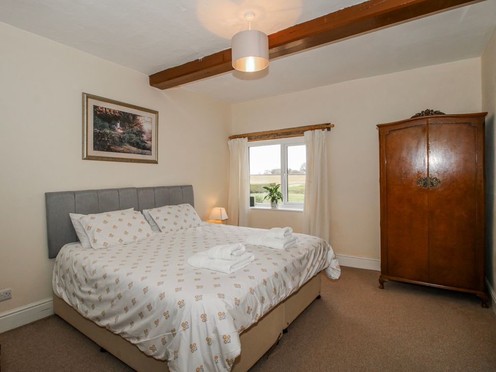 A bedroom with a bed and wardrobe at The Manor House at Kenwick Lodge in Cockshutt near Ellesmere