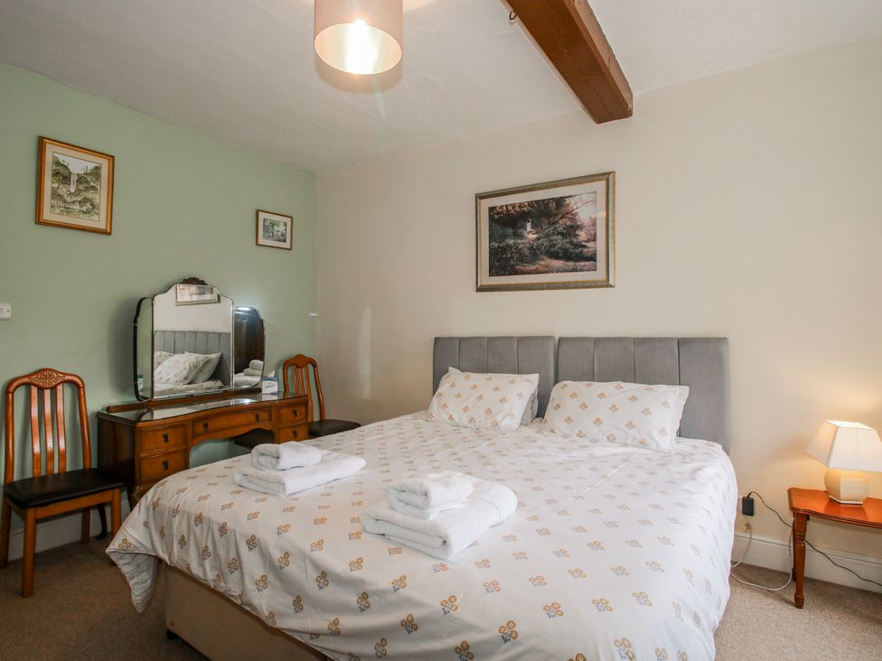 A bedroom with a double bed and dresser at The Manor House at Kenwick Lodge Cockshutt near Ellesmere