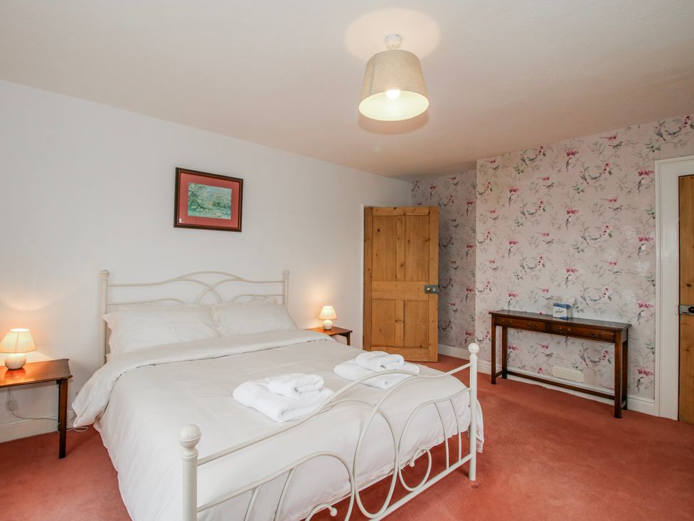 A bedroom with a bed and bedside tables at The Manor House at Kenwick Lodge Cockshutt near Ellesmere