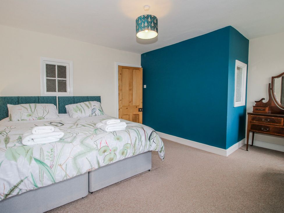 A bedroom with a bed and a mirror at The Manor House at Kenwick Lodge Cockshutt near Ellesmere