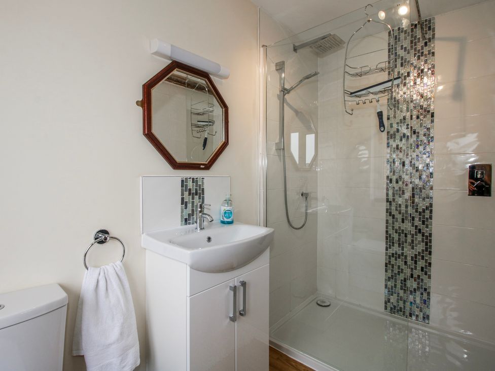 A bathroom with a shower and sink at The Manor House at Kenwick Lodge Cockshutt near Ellesmere