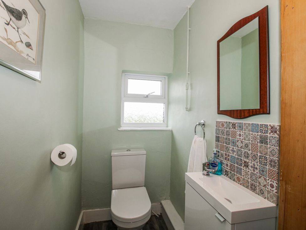 A bathroom with a toilet and sink at The Manor House at Kenwick Lodge Cockshutt near Ellesmere