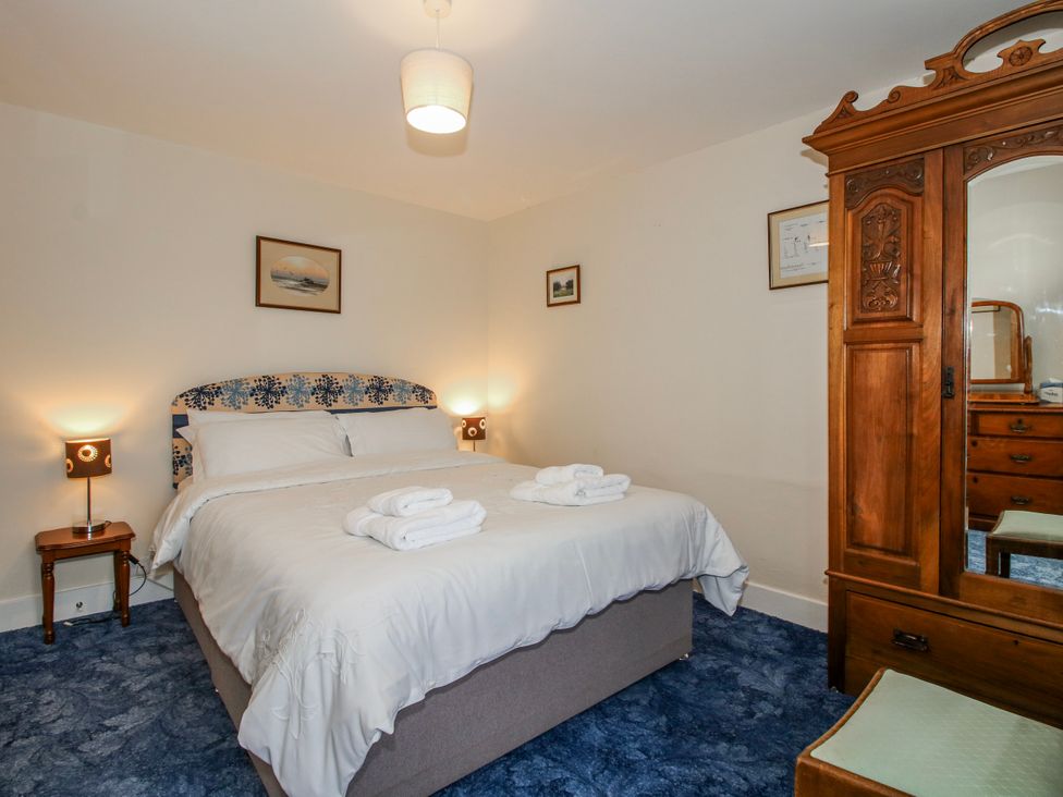 A bedroom with a bed and wardrobe at The Manor House at Kenwick Lodge Cockshutt near Ellesmere