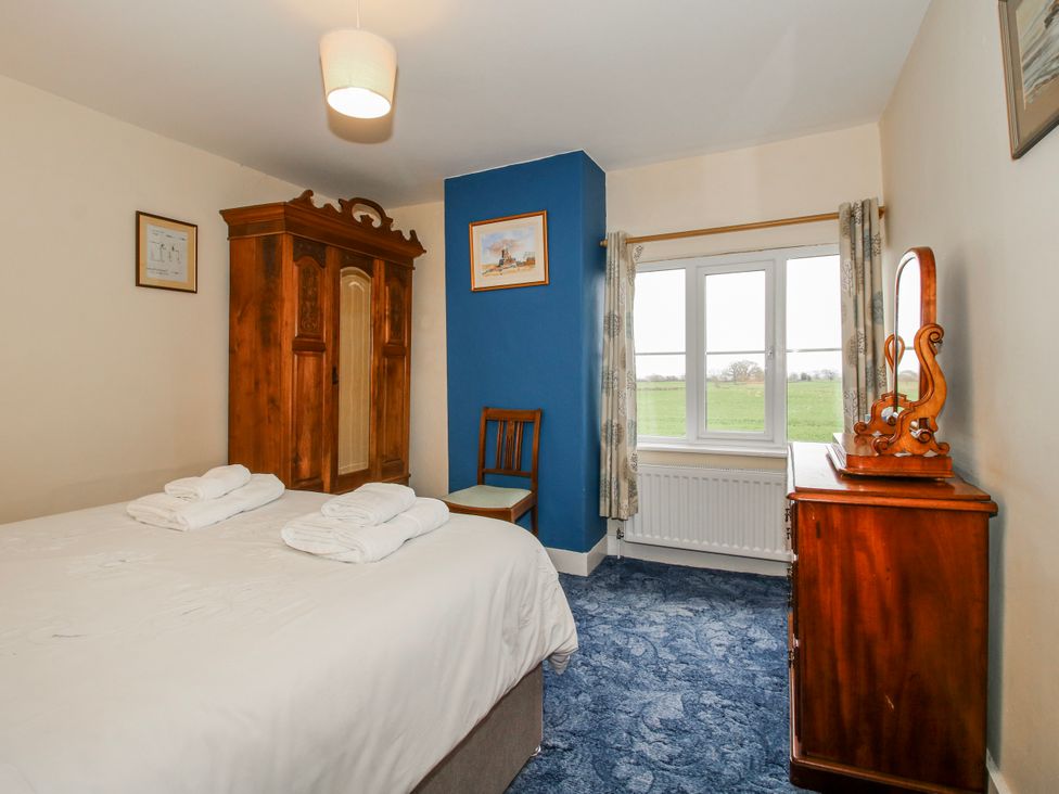 A bedroom with a bed and wardrobe at The Manor House at Kenwick Lodge Cockshutt near Ellesmere