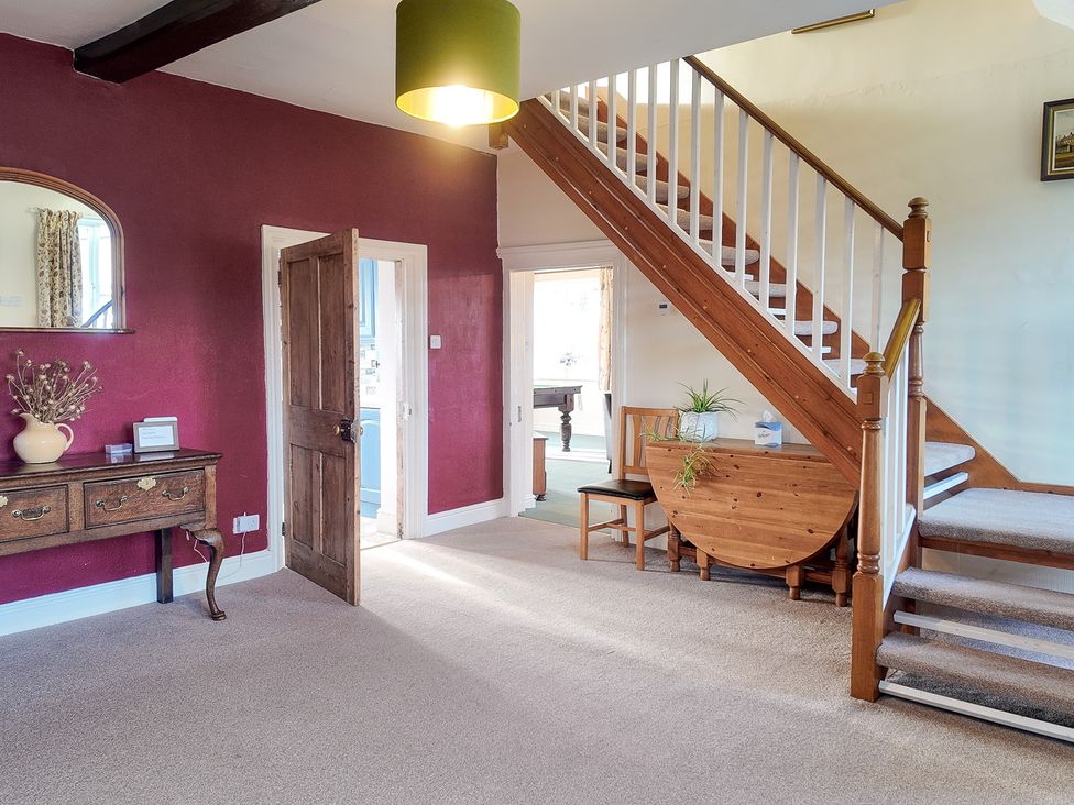 An entrance hall with a staircase and furniture at The Manor House at Kenwick Lodge Cockshutt near Ellesmere