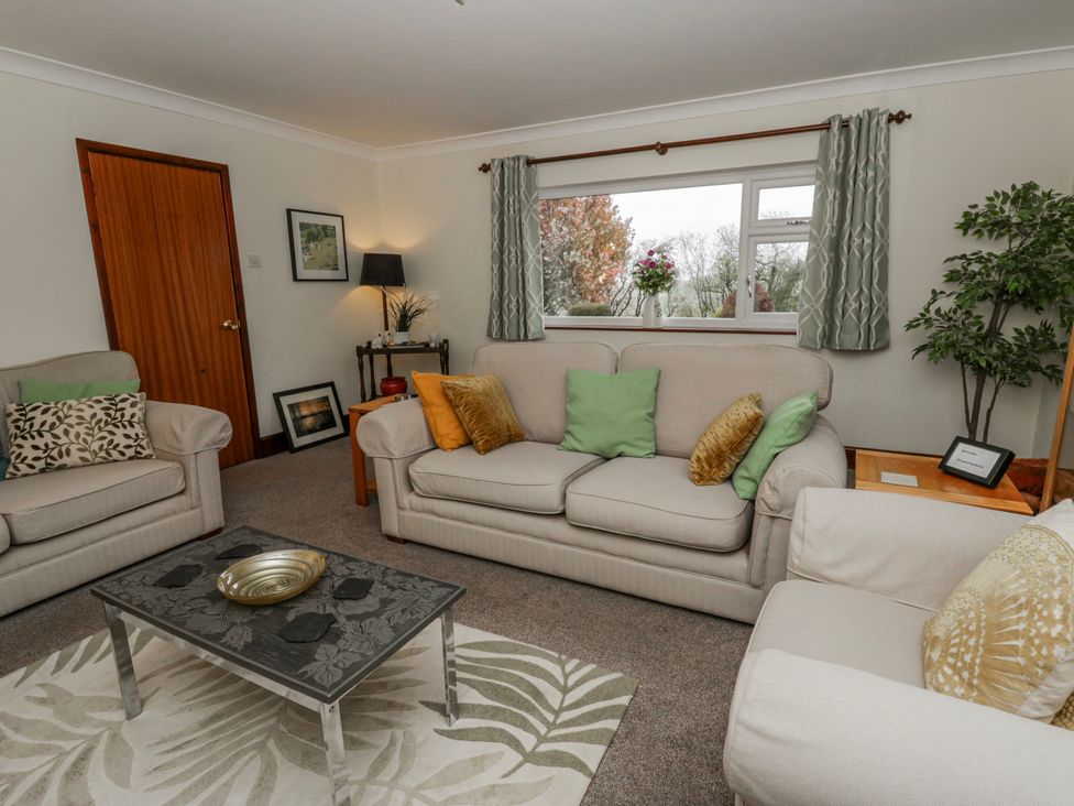 A living room with a sofa and coffee table at Blaenywawr near Lampeter