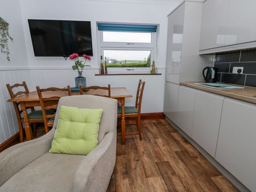 A kitchen with a table and two chairs at Blaenywawr near Lampeter