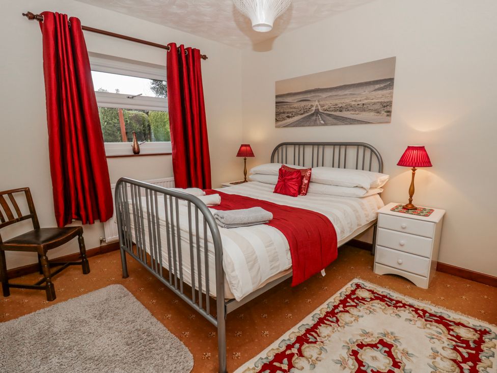 A bedroom with a bed and a bedside table at Blaenywawr near Lampeter