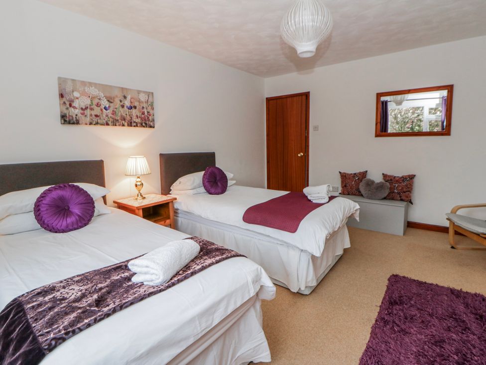 A bedroom with two beds and a lamp at Blaenywawr near Lampeter