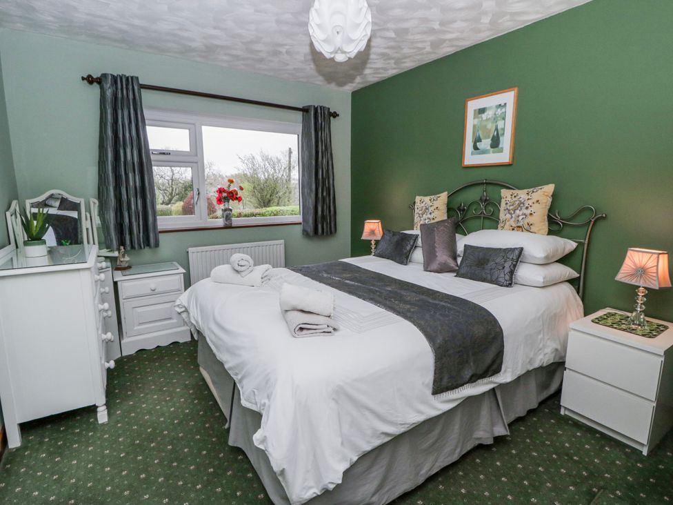 A bedroom with a bed and dresser at Blaenywawr near Lampeter