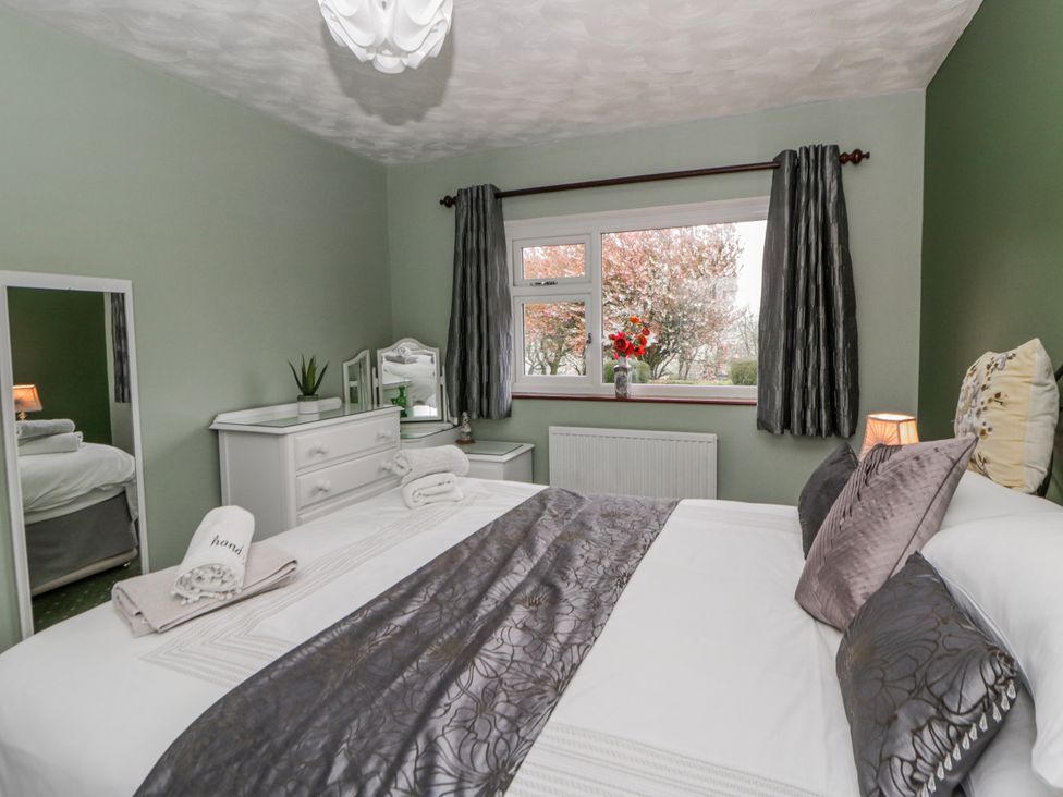 A bedroom with a bed and dresser at Blaenywawr near Lampeter
