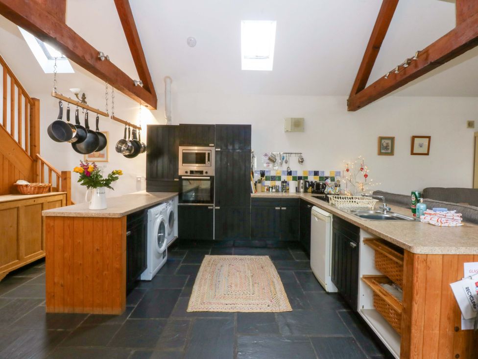 A kitchen with an island and various appliances at Beudy Mawr Y Felinheli