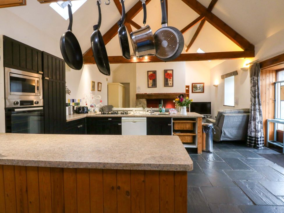 A kitchen with a countertop, sink and oven at Beudy Mawr Y Felinheli