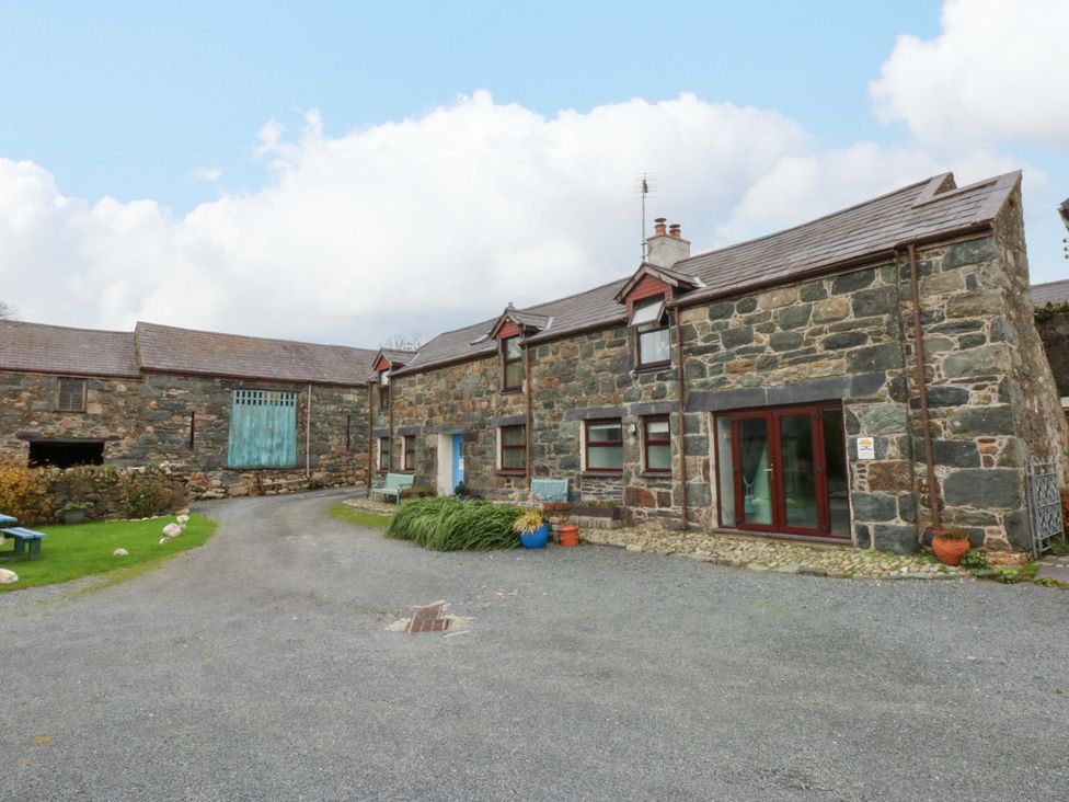 An outdoor area with stone buildings and benches at Hafod Y Felinheli