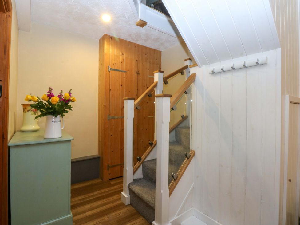 A hallway with a staircase and storage at Hafod Y Felinheli