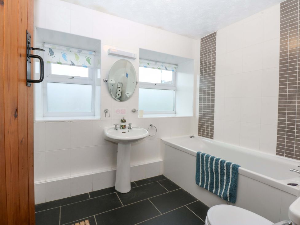 A bathroom with a sink and bathtub at Hafod in Y Felinheli