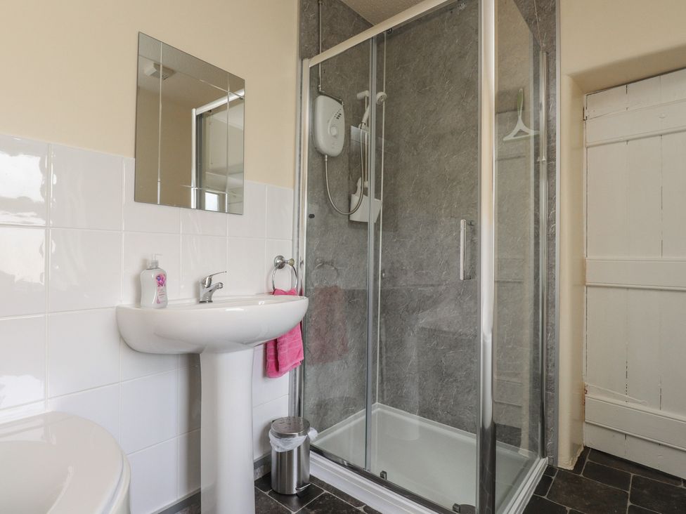 A bathroom with a sink and shower at The Farmhouse in Brynsiencyn near Newborough