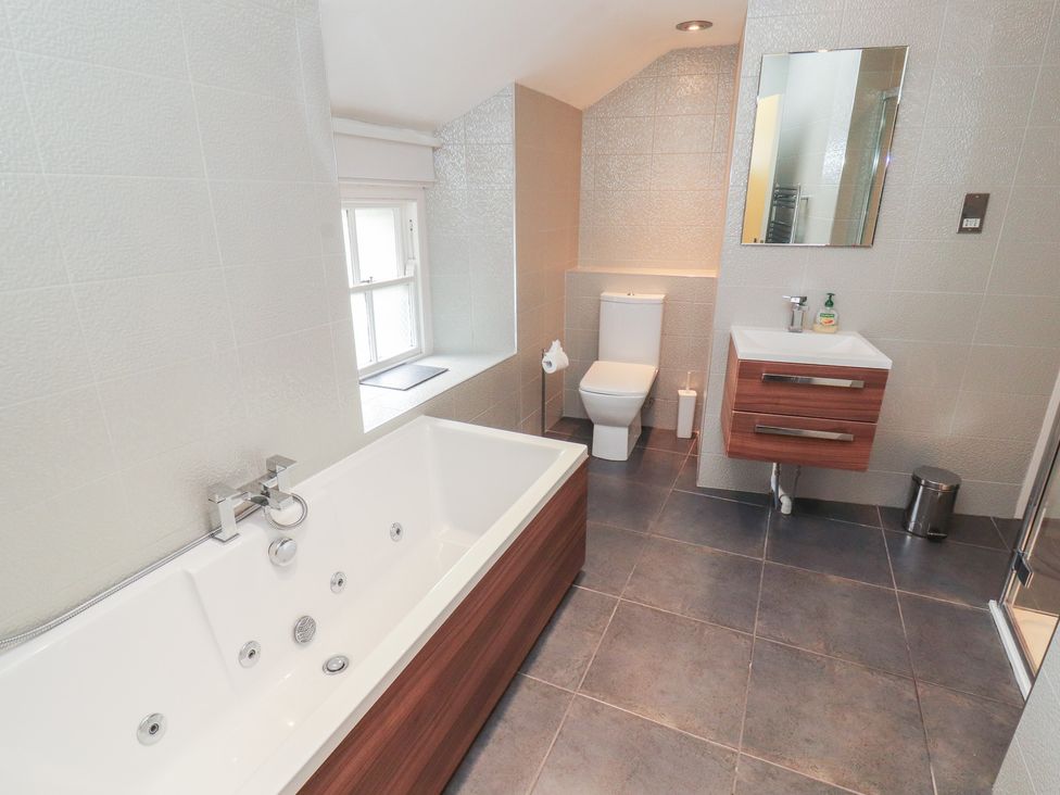 A bathroom with a bathtub, toilet, sink, and shower at Kelsick Heights in Ambleside