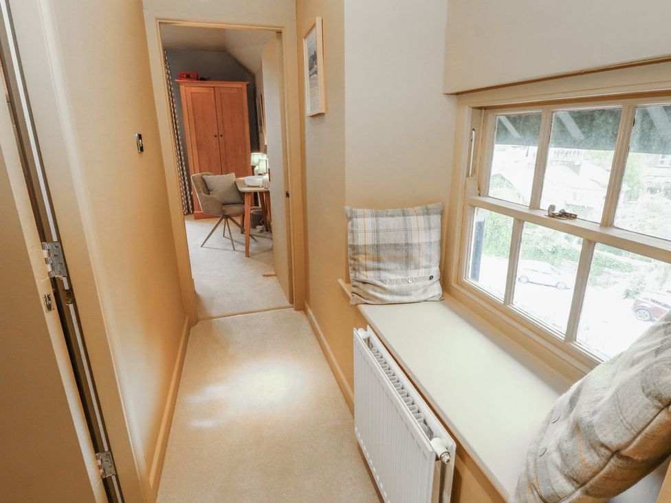 A hallway with a radiator and window at Kelsick Heights in Ambleside