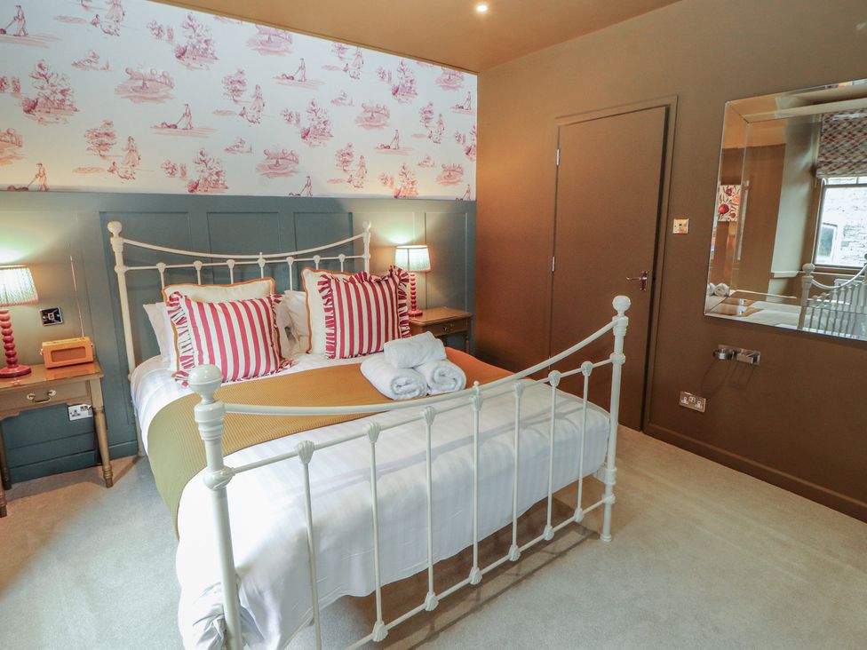 A bedroom with a bed and nightstands at Kelsick Heights, Ambleside
