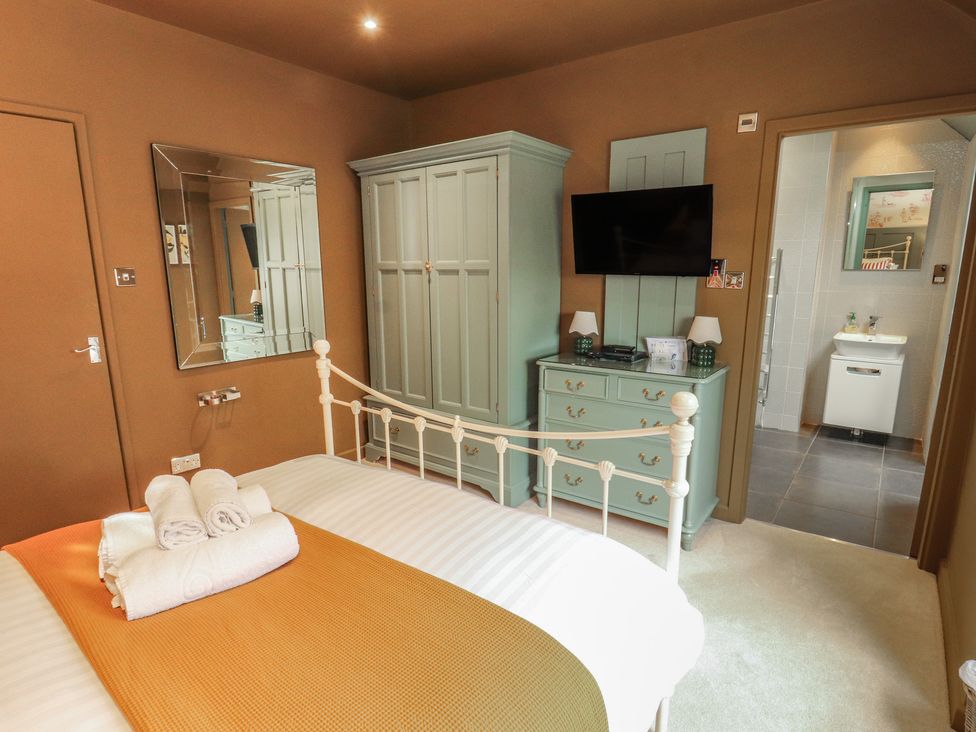A bedroom with a bed and wardrobe at Kelsick Heights in Ambleside