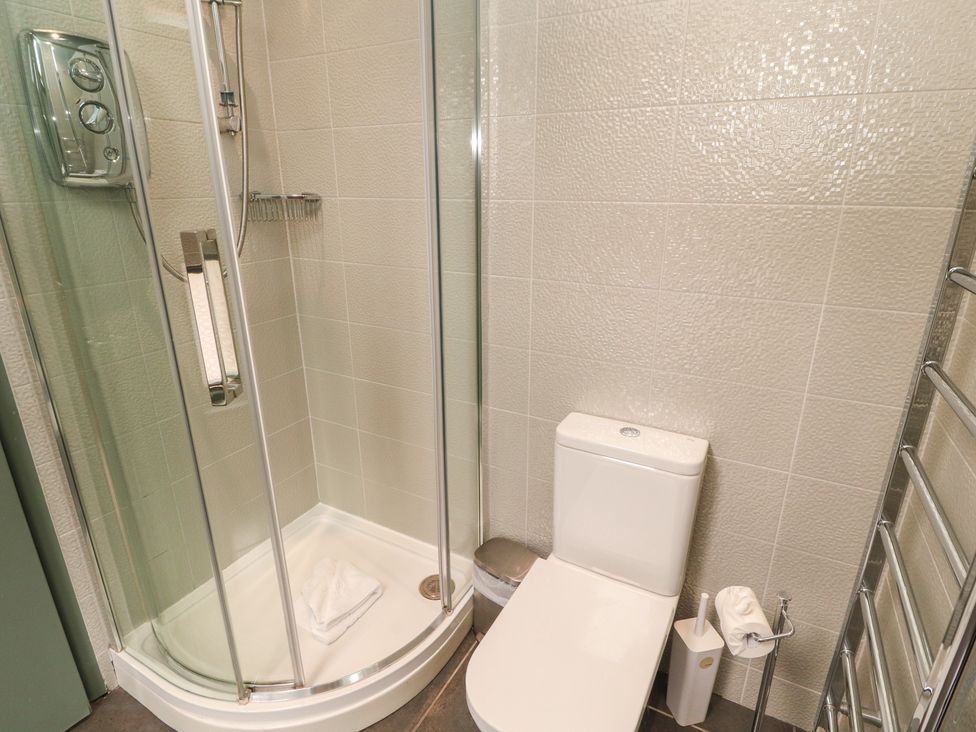A bathroom with a shower and toilet at Kelsick Heights in Ambleside