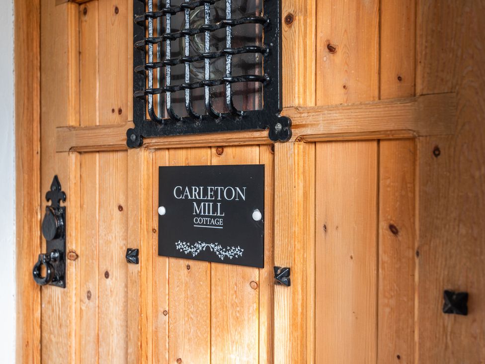 A door with a nameplate at Carleton Mill Cottage in Carlisle