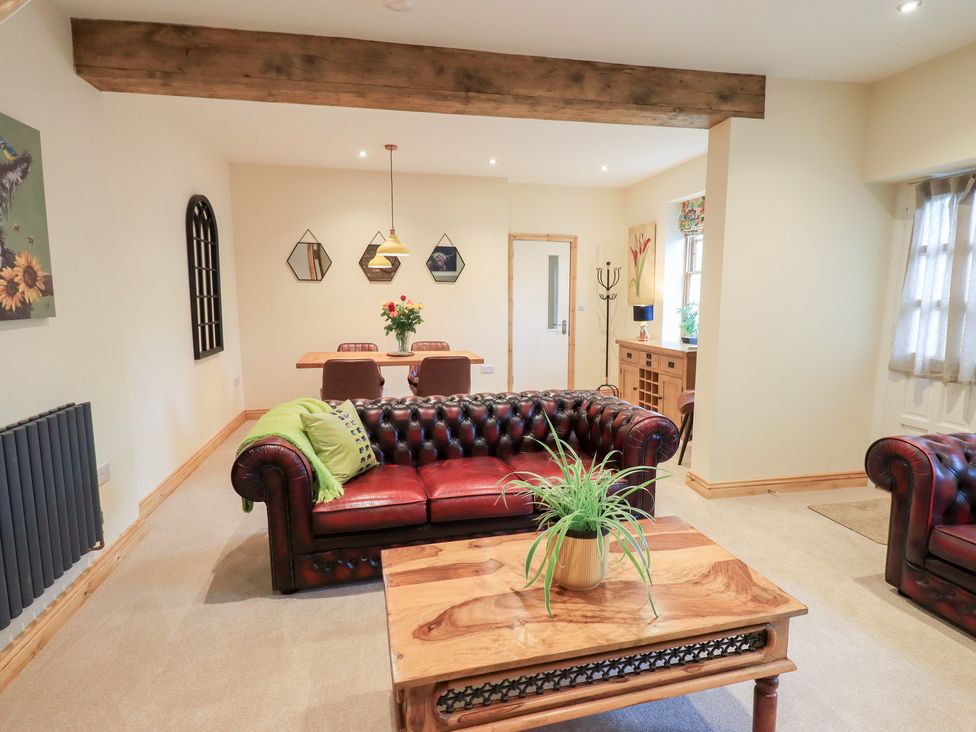 A living room with a sofa and table at Rose Cottage in Crosby on Eden near Carlisle