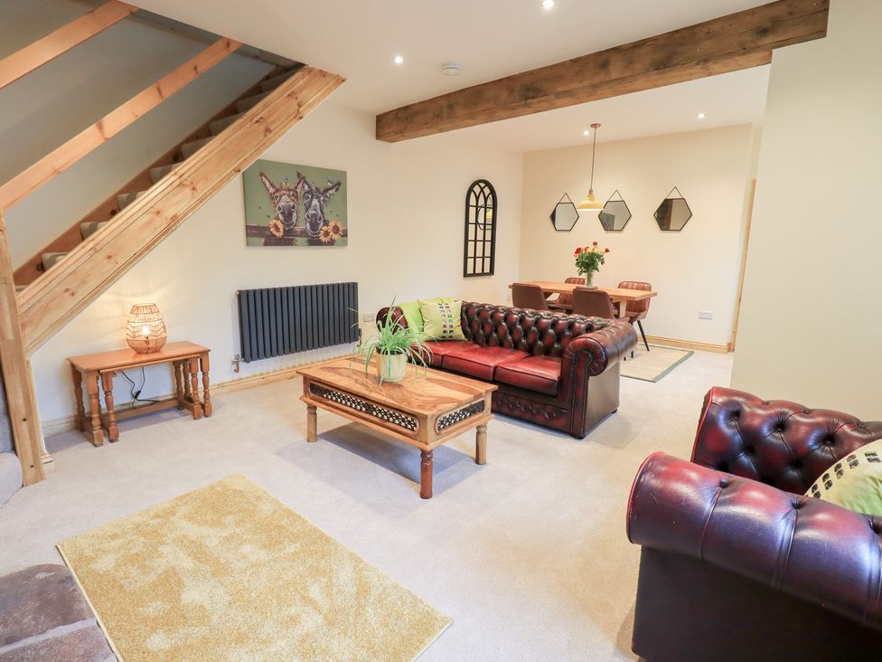 A living room with a sofa and table at Rose Cottage in Crosby on Eden near Carlisle