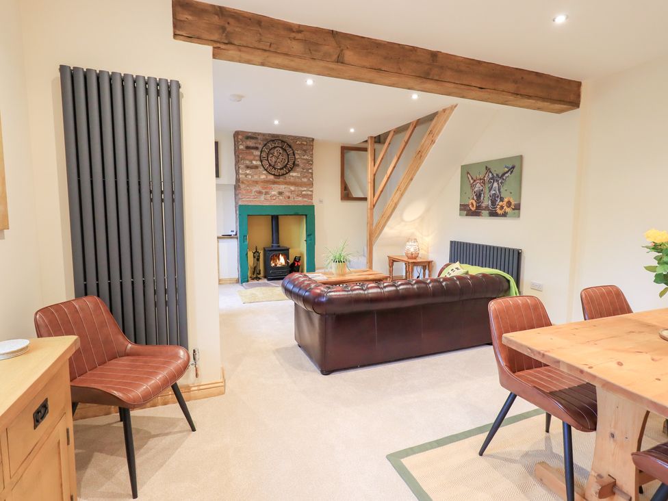 A living room with a sofa and dining table at Rose Cottage in Crosby on Eden near Carlisle