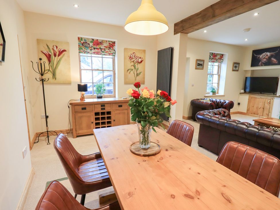 A dining room with a table and chairs at Rose Cottage Crosby on Eden near Carlisle