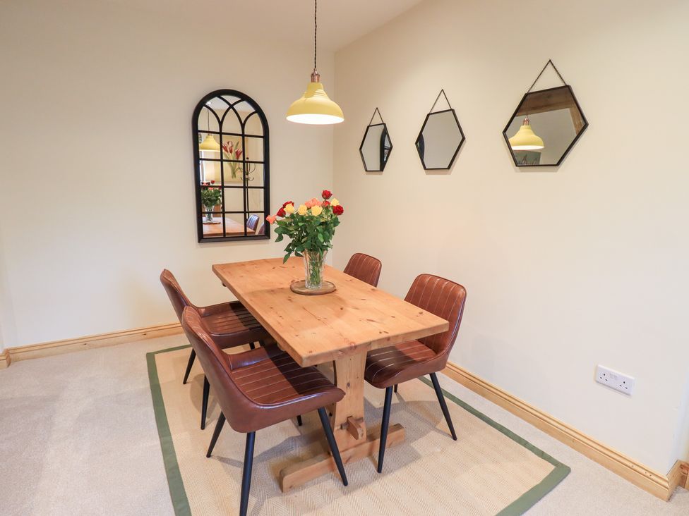 A dining room with a table and chairs at Rose Cottage in Crosby on Eden near Carlisle