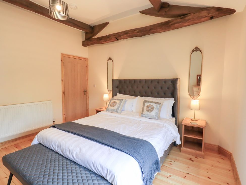 A bedroom with a bed and bedside tables at Rose Cottage in Crosby on Eden near Carlisle