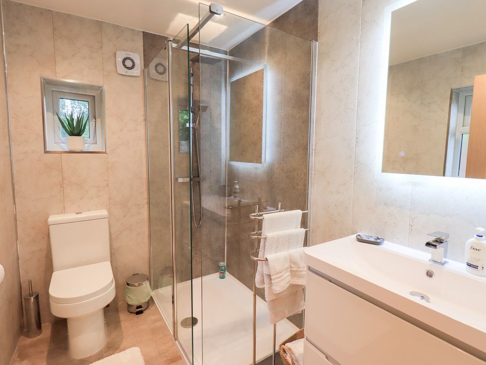 A bathroom with a shower and washbasin at Rose Cottage in Crosby on Eden near Carlisle