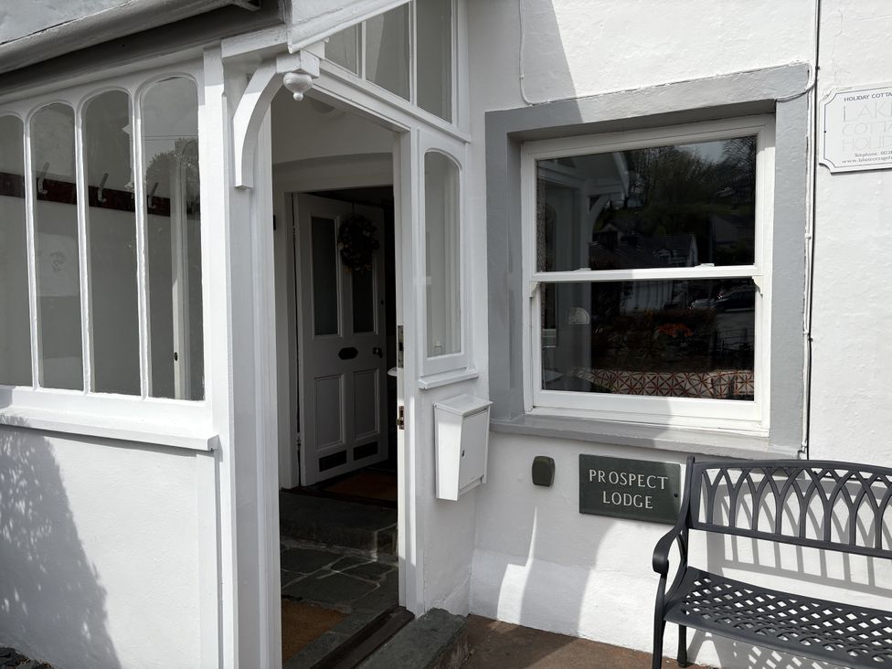 An entrance with a door and a bench at Prospect Lodge in Portinscale