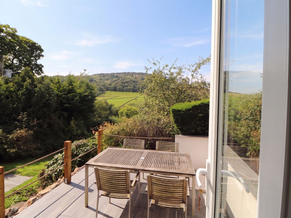 A dining set on a deck at Mell View Cottage in Ullswater