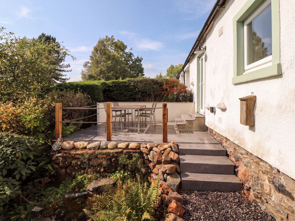 An outdoor patio with a table and chairs at Mell View Cottage in Ullswater