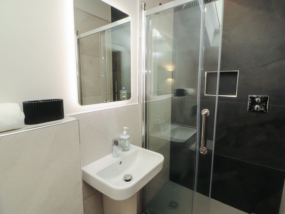 A bathroom with a shower and sink at Mell View Cottage Ullswater