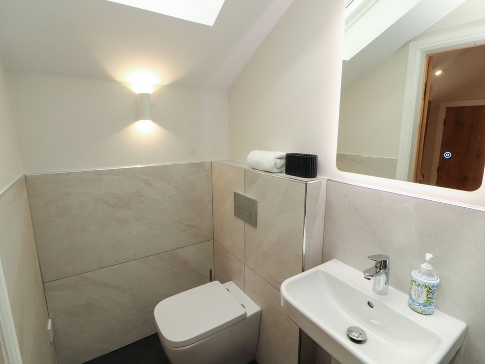 A bathroom with a toilet and hand basin at Mell View Cottage in Ullswater