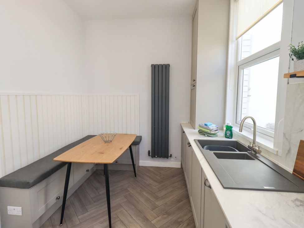 A kitchen with a dining table and sink at St Johns View in Keswick