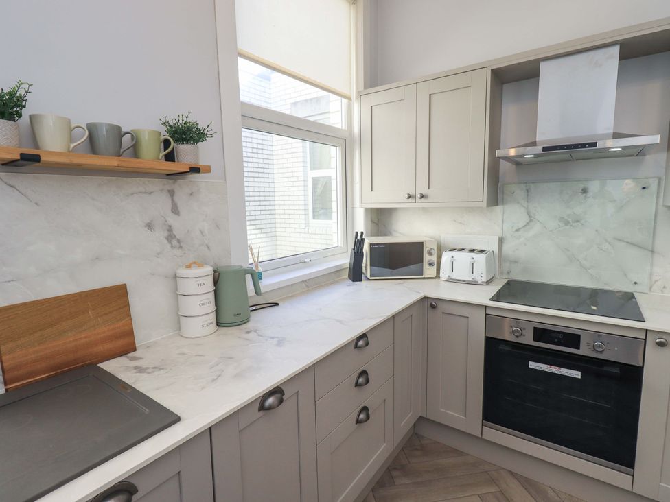 A kitchen with cabinets, appliances, and countertop at St Johns View in Keswick