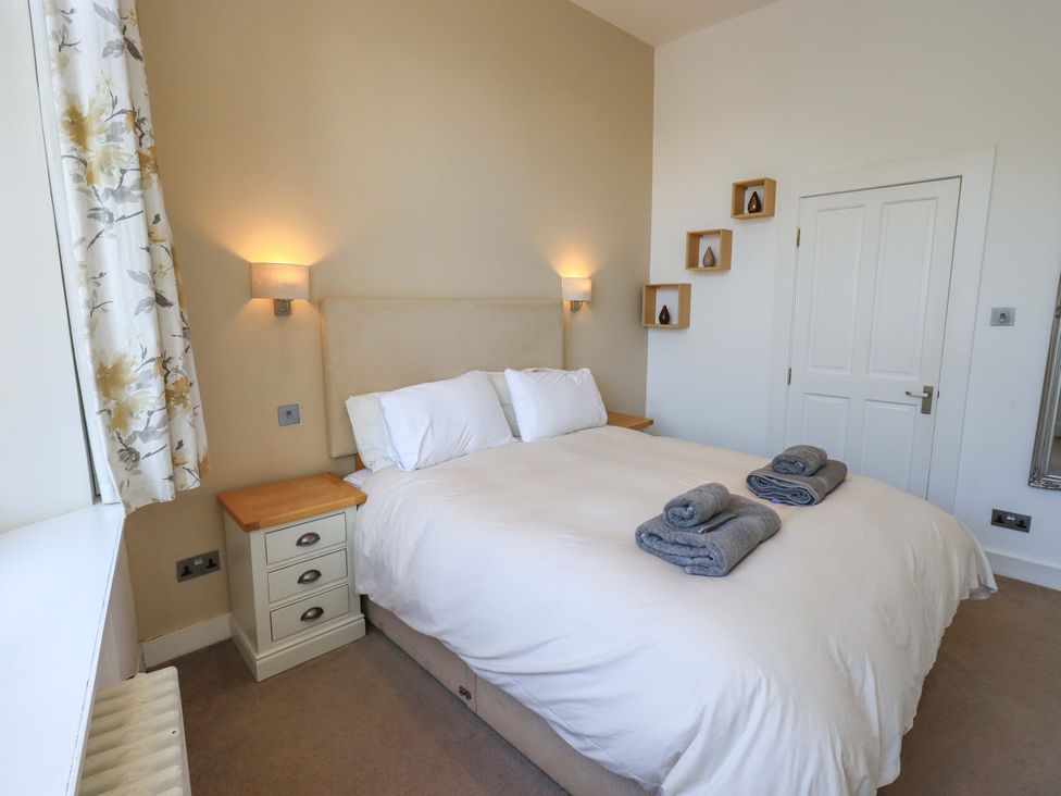 A bedroom with a bed and bedside table at St Johns View in Keswick